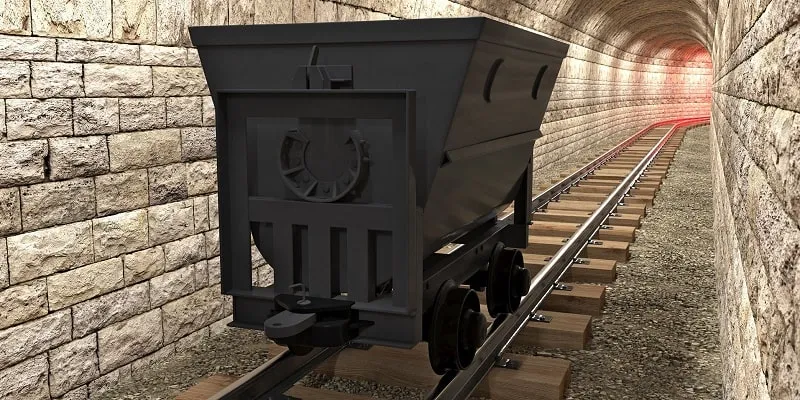 واگن معدنی در حال حرکت روی ریل‌های آهنی در یک تونل زیرزمینی
